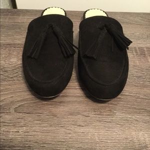 Black suede tasseled mules by Crown & Ivy